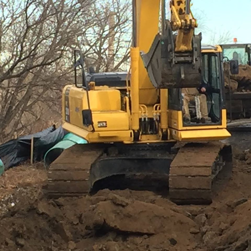 Excavator digging trenches